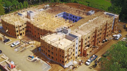 A multi-story wood frame buildings in progress.