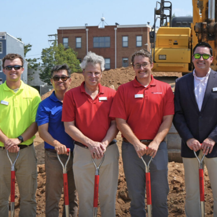 Harkins employees smiling at a groundbreaking ceremony.